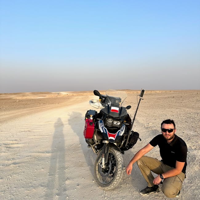 Motorbike and rider on a desert road in saudi arabia, edge of the world