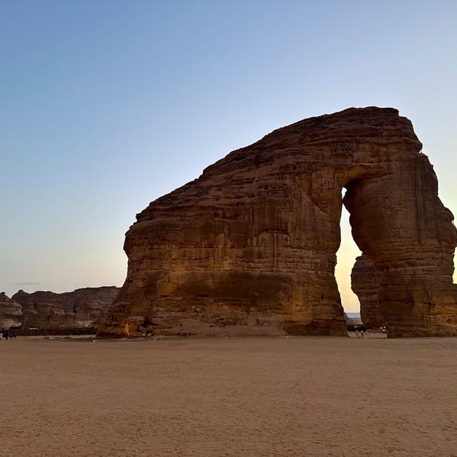 Saudi arabia, al ula elephant rock, a sandstone rock formation with a natural arch at sunset