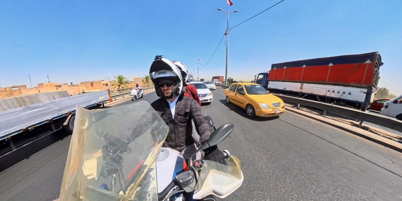 Iraq, baghdad filip and jadzia on motorcycle in the city