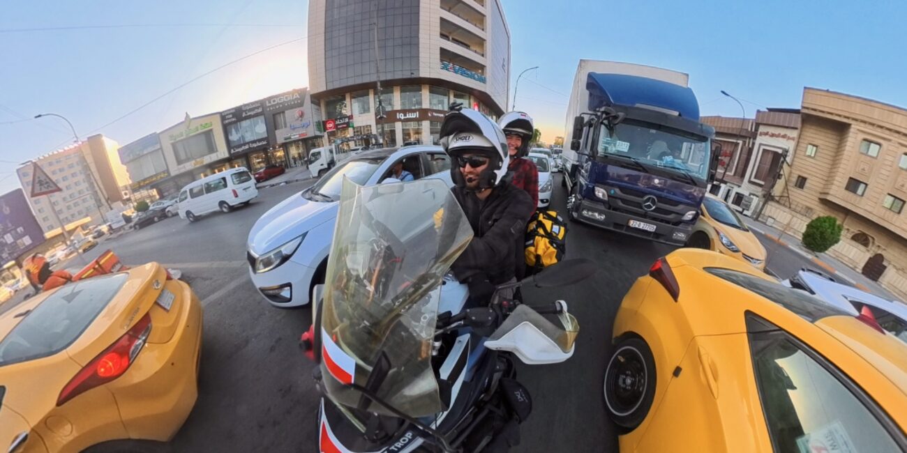 Iraq, baghdad filip and jadzia on motorcycle in the city